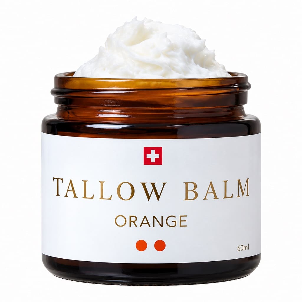 Swiss Tallow Balm Orange 60 ml – natürliche Schweizer Talgcreme aus Rindertalg im braunen Glastiegel mit weisser, fluffiger Creme auf weissem Hintergrund.